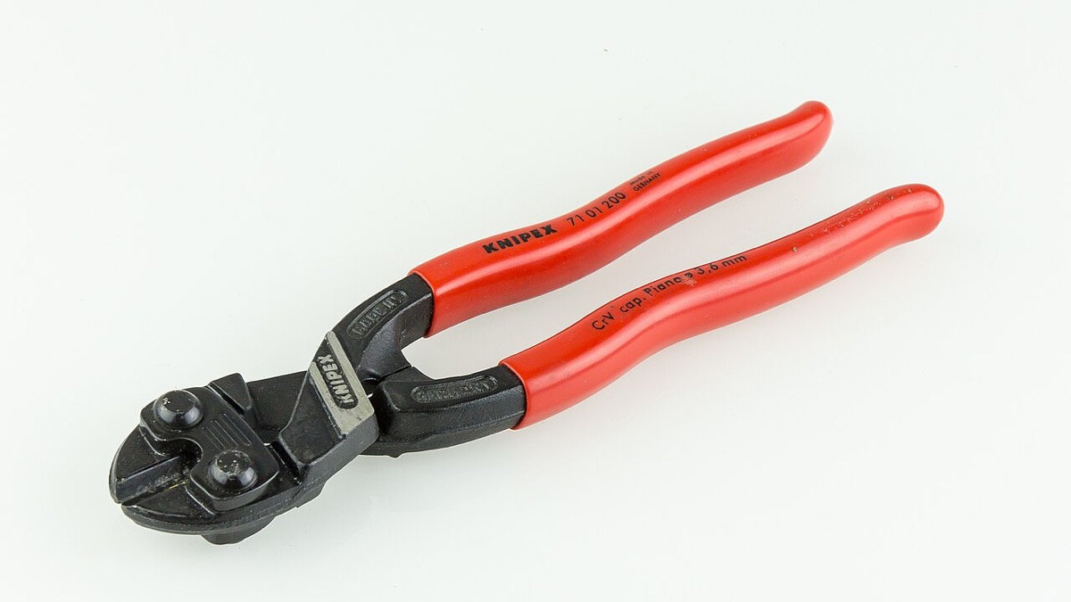 A KNIPEX CoBolt compact bolt cutter with red plastic-coated handles and a black head, on a white background