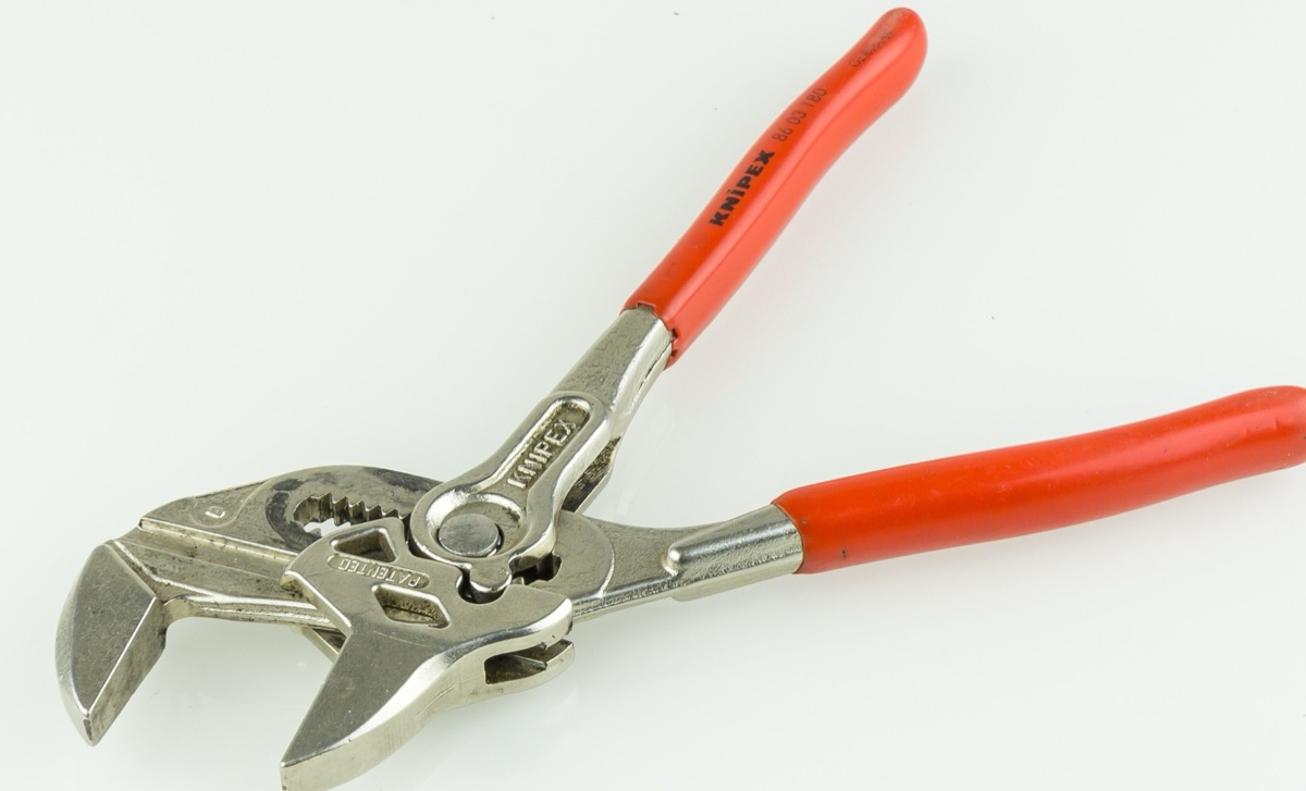 A KNIPEX pliers wrench with red plastic-coated handles and chrome jaws on a white background